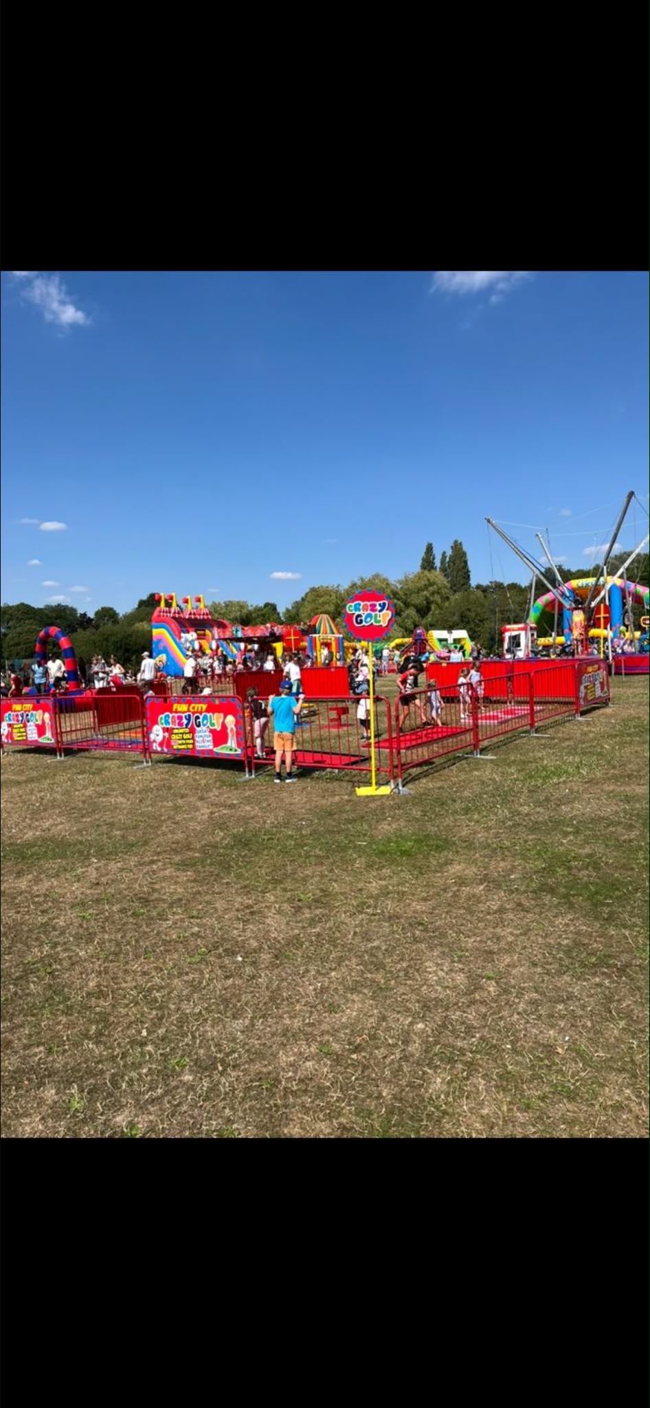 A colourful crazy golf course set up outdoors at a fun day